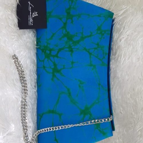 Blue and Green clutch on a shag carpet